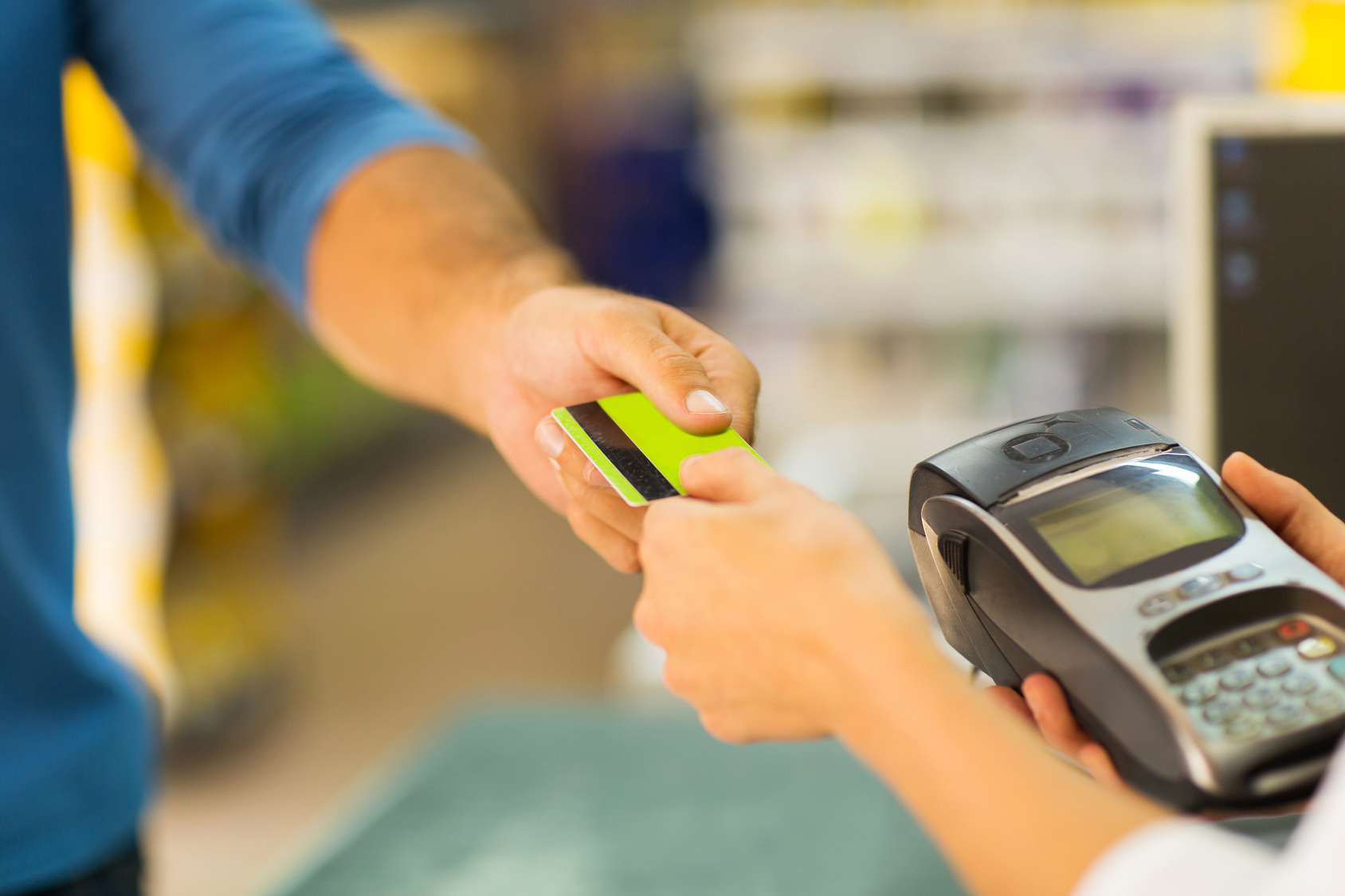 customer paying with credit card at supermarket